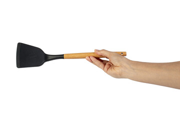 Hand with Black plastic kitchen spatula, kitchenware for cooking on transparent background.