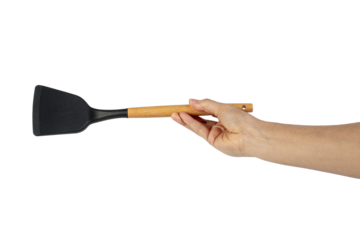 Hand with Black plastic kitchen spatula, kitchenware for cooking on transparent background.
