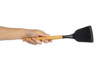 Hand with Black plastic kitchen spatula, kitchenware for cooking on transparent background.
