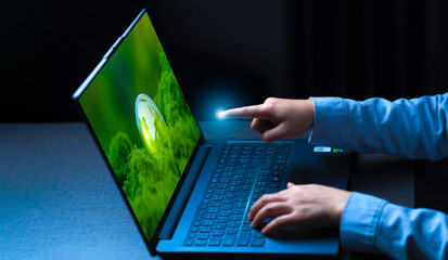 Businessman controls laptop on digital screen with forest, green technology, environmental control and green future.