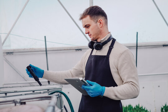 Physiologist analyzing tulip growth conditions carefully, Agricultural scientist conducting detailed experiments on tulips using specialized equipment and careful measurements