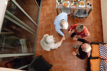 A group of four friends snapping their fingers in the center while dancing in a circle