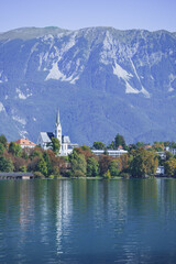Fototapeta premium Saint Martin’s Church in Lake Bled. Lake with iconic Island and Castle, Slovenia. Romantic spot. 