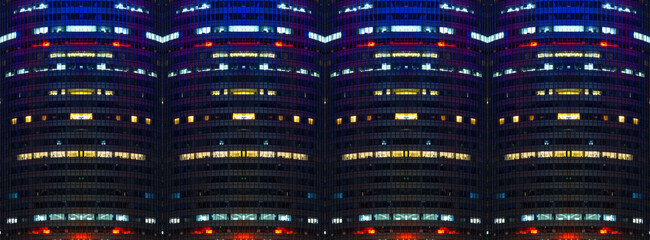 Multi-stories office building at night with worker working overtime. late night at office. lighting and working people within