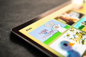 Cartoon videos in tablet for kids. Game or movie for children of family. Animated series for child. Mockup tv stream service. Screen time and internet limit concept. Online gaming with pad.