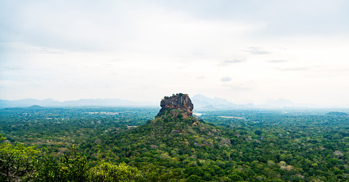 Sigiriya, Sri Lanka. Lion's Rock from Pidurangala mountain. Fortress, temple and monument. Panorama view to beautiful landscape. World heritage site tourism. Dambulla, Srilanka. Green forest in nature