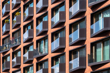 Modern residential housing in HafenCity displays a dynamic geometric facade and prominent structure motifs visible throughout Hamburg Germany unified under cohesive contemporary design principles