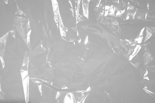 Transparent plastic wrap texture overlay effect. polyethylene wrapping stretch film background. Shrink crumpled plastic sleeve surface.