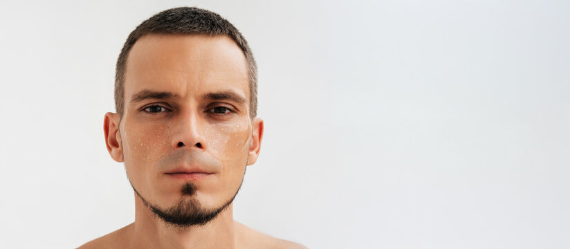 Portrait of a man using under-eye cosmetic patches