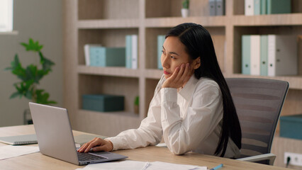 Brainstorming pensive Asian Japanese office worker employer business woman Chinese Korean female businesswoman entrepreneur thinking have idea pointing index finger thought work laptop desktop indoor