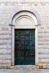 The bronze doors of the Church of St. Mary Collegiate or the church of St. Osanna depicting the saint's life, city of Kotor. Montenegro.