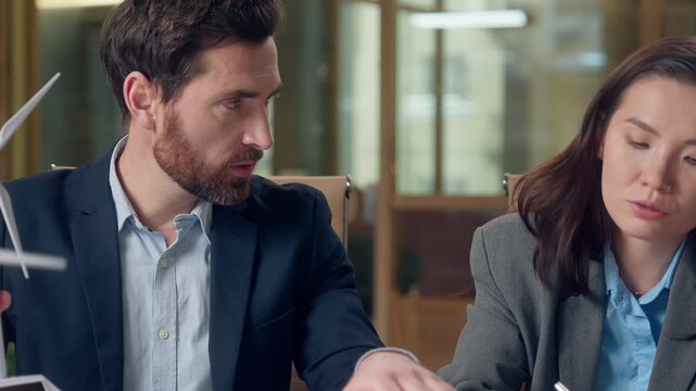 Multiracial group Korean business woman Caucasian man demonstrate windmill model envision sustainable electricity wind future brainstorming talk clean energy solution partnership indoor eco startup