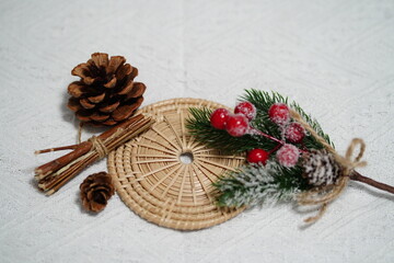 Festive Arrangement of Pinecones, Colorful Berries, and Natural Elements on a Textured White Fabric Background for Seasonal Decor