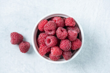 Group of fresh raspberries in a bowl. Juicy summer berries