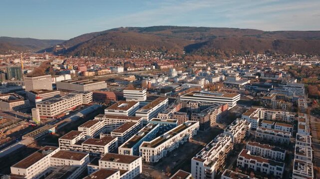 Urban Transition: Aerial View Contrasting Heidelberg's Modern Passive House District with the Historic Cityscape and Hilly Surroundings
