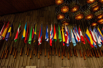 Obraz premium A collection of vibrant flags from around the world on display inside the Basilica of Santa María de Guadalupe in Mexico City.