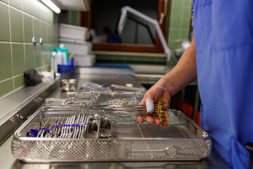 Sterile surgical instruments being prepared in a hospital sterilization room.