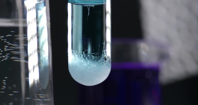 Chemical Laboratory Smooth Zoom Test Tube with Oxalic Acid Solution Crystal Formation Snowflake Sediment Falling to Bottom Scientific Experiment Research Process Education Analytical Chemistry