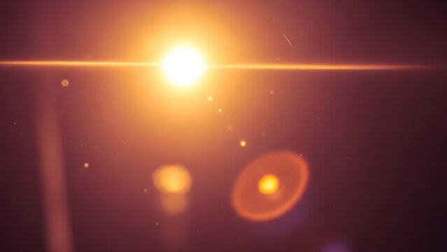 Bright orange-yellow light source with strong lens flare and bokeh against dark background - Powered by Adobe