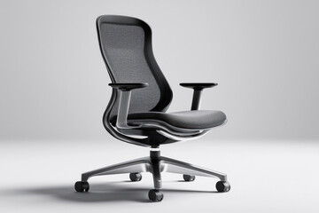 Fototapeta premium Sleek black ergonomic office chair featuring a mesh back, padded seat, adjustable armrests, and five-star wheeled base.