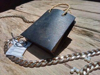 Black Shopping Bag with White Flowers on Moss Background &ndash; Natural Decorative Still Life