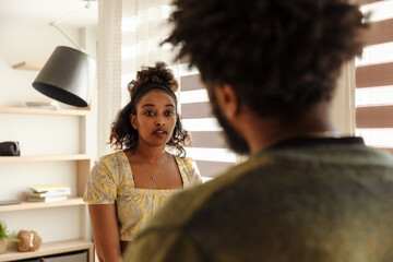 A female musician listens to a male musician standing across from her
