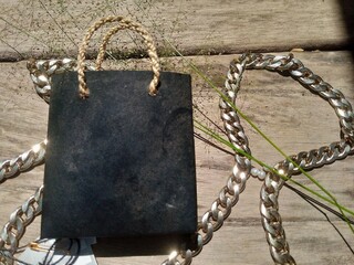 Black Shopping Bag with White Flowers on Moss Background &ndash; Natural Decorative Still Life