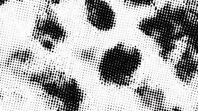 A close-up view of a black and white spotted pattern that resembles a cow's hide, featuring various-sized spots in a dotted style.