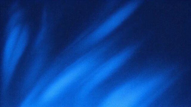Abstract blue background with soft light patterns creating a serene atmosphere.