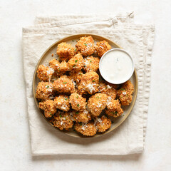 Crispy breaded oven baked cauliflower bites served with dipping sauce