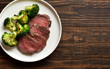 Beef steak served with roasted broccoli