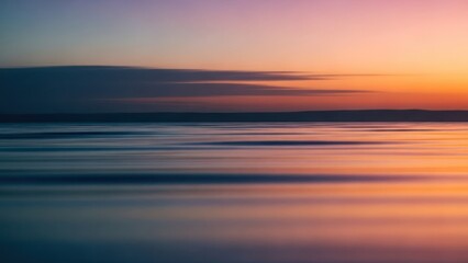 Long exposure captures colorful sky reflecting vibrant orange, pink, blue over water