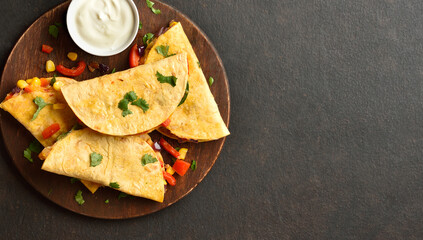 Delicious quesadilla with fresh vegetables served with sauce