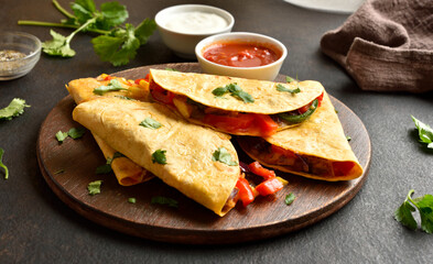 Delicious quesadilla with fresh vegetables served with sauce