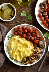 Mashed potatoes with roasted sweet and spicy sausage bites and mushrooms