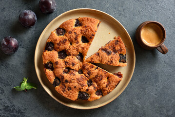 Warm autumn plum pie on plate