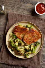 Juicy grilled pork steak served with roasted broccoli