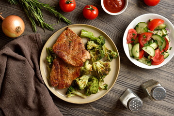 Juicy grilled pork steak served with roasted broccoli