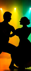 A silhouette of a couple performing a classical dance 