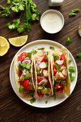 Tacos with vegetables and meat on wooden background
