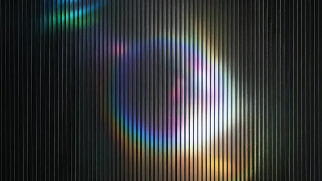 Colorful light patterns with a rainbow effect against a textured background.