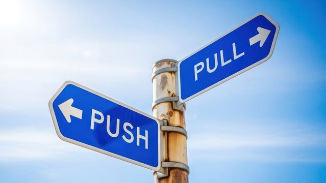 Two blue signs on a pole, pointing opposite ways, read PUSH and PULL against blue sky