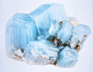 A cluster of raw aquamarine crystals in pale blue with hexagonal formations, isolated on pure white background.