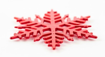 Vibrant red decorative snowflake with six intricate points, isolated on white background