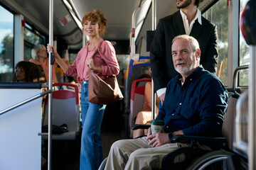 Senior man using wheelchair on public bus