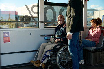 Senior man in wheelchair traveling on public bus