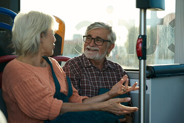 Senior couple enjoying conversation on public bus © alvaro