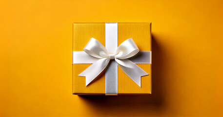 Gift. Yellow gift box with bow on yellow background isolated. Christmas and Valentine's Day.