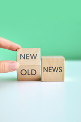New or Old News â€“ Concept with Wooden Blocks and Hand Turning Cube