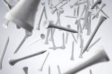 Many floating golf tees on white background